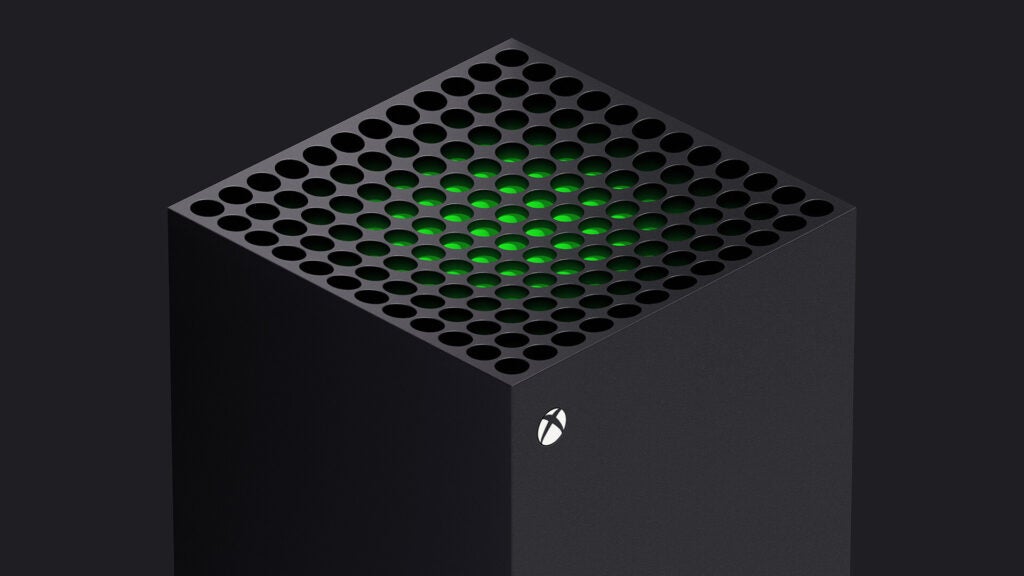 Vista lateral superior frontal de una Xbox gris sobre un fondo negro